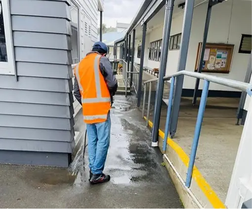 pressure washing a dirty concrete pathway